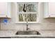 Close-up of a kitchen sink with stainless steel faucet, granite countertop, and white tile backsplash at 2374 Buchanan Hwy, Dallas, GA 30157