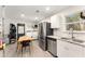 An open area shows stainless appliances, granite countertops and a laundry area at 2374 Buchanan Hwy, Dallas, GA 30157