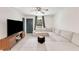 Cozy living room featuring a plush sectional sofa, modern ceiling fan and a large flat screen television at 2374 Buchanan Hwy, Dallas, GA 30157