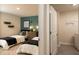 Charming bedroom featuring two twin beds, a turquoise accent wall, and shared nightstand at 3058 Yellowhammer Dr, Marietta, GA 30064