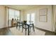 Modern dining area with a black table, neutral decor, and ample natural light from large windows at 3058 Yellowhammer Dr, Marietta, GA 30064