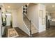 Welcoming entryway with staircase, modern decor, wood floors, and access to the kitchen at 3058 Yellowhammer Dr, Marietta, GA 30064