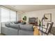 Cozy living room featuring a comfortable gray sofa, large window, and stylish decor at 3058 Yellowhammer Dr, Marietta, GA 30064