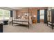 Well-lit main bedroom with a canopy bed, carpet, modern furniture, and a cozy atmosphere at 3058 Yellowhammer Dr, Marietta, GA 30064