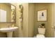 Stylish powder room features a pedestal sink, modern decor, and light green walls at 3058 Yellowhammer Dr, Marietta, GA 30064