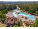 A stunning aerial view showcases the community pool and clubhouse surrounded by lush greenery at 4126 Gold Mill Rdg, Canton, GA 30114