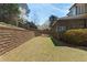 The spacious yard features a retaining wall and provides privacy and space for outdoor activities at 4126 Gold Mill Rdg, Canton, GA 30114