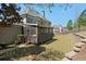 Expansive backyard featuring a screened porch and a terraced retaining wall for optimal outdoor enjoyment at 4126 Gold Mill Rdg, Canton, GA 30114