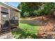 A quaint screened porch opens onto a verdant backyard with a tiered retaining wall at 4126 Gold Mill Rdg, Canton, GA 30114