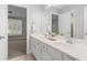 Bright bathroom featuring a double sink vanity with neutral countertops, and an open view to bedroom space at 4126 Gold Mill Rdg, Canton, GA 30114
