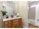 Well-lit bathroom featuring a vanity with sink, mirror, shower and toilet at 4126 Gold Mill Rdg, Canton, GA 30114