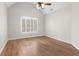 Bright bedroom featuring vaulted ceiling, ceiling fan, hardwood floors and large window with plantation shutters at 4126 Gold Mill Rdg, Canton, GA 30114