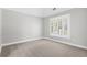 Bright bedroom featuring a vaulted ceiling, neutral carpet, and a large window with plantation shutters at 4126 Gold Mill Rdg, Canton, GA 30114