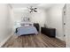 This bedroom offers hardwood floors, neutral walls, and a ceiling fan at 4126 Gold Mill Rdg, Canton, GA 30114