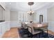 Dining room with hardwood floors, a decorative chandelier, and views of the landscaped yard at 4126 Gold Mill Rdg, Canton, GA 30114