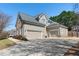 Attractive home exterior with a three-car garage, a basketball hoop and well-manicured landscaping at 4126 Gold Mill Rdg, Canton, GA 30114