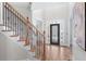 Spacious foyer with hardwood floors, staircase with iron railings, and decorative glass front door at 4126 Gold Mill Rdg, Canton, GA 30114
