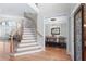 Bright foyer showcasing hardwood floors, elegant staircase, and dining room entrance at 4126 Gold Mill Rdg, Canton, GA 30114