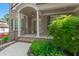 Inviting brick home with a covered front porch, white pillars, and neatly landscaped garden at 4126 Gold Mill Rdg, Canton, GA 30114