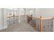 Upstairs hallway with carpet and dark metal railing at 4126 Gold Mill Rdg, Canton, GA 30114