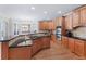 Open kitchen with granite countertops, stainless steel appliances, and hardwood floors at 4126 Gold Mill Rdg, Canton, GA 30114