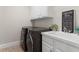 Well-organized laundry room features modern washer and dryer, sink, and decor at 4126 Gold Mill Rdg, Canton, GA 30114