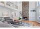 Bright living room featuring a stone fireplace, built-in shelving, and cathedral ceiling at 4126 Gold Mill Rdg, Canton, GA 30114