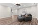 This living room is equipped with a ceiling fan, wood flooring, and comfortable seating at 4126 Gold Mill Rdg, Canton, GA 30114