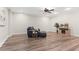 This living room is equipped with a ceiling fan, wood flooring, and comfortable seating at 4126 Gold Mill Rdg, Canton, GA 30114