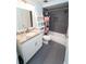 Well-lit bathroom featuring a shower-tub combo, modern vanity with granite countertops, and stylish ladder shelving at 5400 Roswell Rd # K2, Atlanta, GA 30342