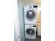 Convenient laundry area with a stacked washer and dryer set, optimizing space in a modern design at 5400 Roswell Rd # K2, Atlanta, GA 30342