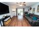 Bright living room featuring hardwood floors, a ceiling fan and sliding glass doors to the outside at 5400 Roswell Rd # K2, Atlanta, GA 30342