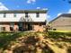 Spacious backyard with a patio and two-story house, perfect for outdoor activities and relaxation at 1005 Magnolia Gardens Walk, Mcdonough, GA 30253