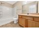 Bright bathroom with a tub and shower combination and light wood vanity at 1005 Magnolia Gardens Walk, Mcdonough, GA 30253