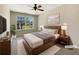 Well-lit bedroom featuring a comfortable bed, ceiling fan and large window with a view at 1005 Magnolia Gardens Walk, Mcdonough, GA 30253