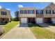 Charming townhome with a brick facade, attached garage and well maintained lawn at 1005 Magnolia Gardens Walk, Mcdonough, GA 30253