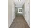 Hallway with neutral paint and carpet flooring leading to a bright living space at 1005 Magnolia Gardens Walk, Mcdonough, GA 30253