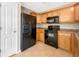 Kitchen with stainless steel refrigerator and black appliances at 1005 Magnolia Gardens Walk, Mcdonough, GA 30253
