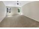 Spacious main bedroom with neutral carpet, ceiling fan, and two windows at 1005 Magnolia Gardens Walk, Mcdonough, GA 30253