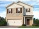 Charming two-story home with a two-car garage and neutral-tone siding at 104 Hill Side Ln, Dallas, GA 30157