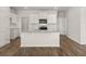 Bright kitchen with white cabinets, a granite island, and stainless steel appliances at 104 Hill Side Ln, Dallas, GA 30157