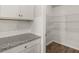 Walk-in pantry featuring wire shelving, granite countertops, and ample storage space at 104 Hill Side Ln, Dallas, GA 30157