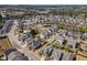 An aerial view of a well maintained neighborhood with mature trees, sidewalks, and a community swimming pool at 307 Montgomery Way, Woodstock, GA 30188