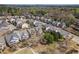 An aerial view of a residential neighborhood showcasing well-maintained homes, mature trees, and manicured lawns at 307 Montgomery Way, Woodstock, GA 30188