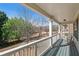 Outdoor space featuring a covered porch with railings, chairs, and a view of the landscaped backyard at 307 Montgomery Way, Woodstock, GA 30188