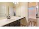 Bathroom featuring a vanity with sink and a door leading to the shower and toilet room at 307 Montgomery Way, Woodstock, GA 30188