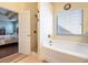Bright bathroom featuring a shower, soaking tub and linen closet, offering both convenience and relaxation at 307 Montgomery Way, Woodstock, GA 30188