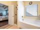 Bathroom featuring a soaking tub, separate shower, and connection to bedroom at 307 Montgomery Way, Woodstock, GA 30188
