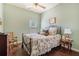 Inviting bedroom with floral bedspread, hardwood floors, and natural light at 307 Montgomery Way, Woodstock, GA 30188