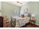 Bedroom features natural light from the window, a ceiling fan, and traditional-style furniture at 307 Montgomery Way, Woodstock, GA 30188